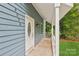 Close-up of the home's blue exterior and welcoming front porch at 8338 Rittenhouse Cir, Charlotte, NC 28270