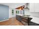 Modern kitchen featuring stainless steel appliances, sleek countertops, and wood flooring at 8338 Rittenhouse Cir, Charlotte, NC 28270