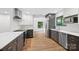 Well-lit kitchen with modern appliances, contrasting cabinets, and hardwood floors at 8338 Rittenhouse Cir, Charlotte, NC 28270