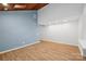 Spacious living room with wood ceiling, light blue accent wall and hardwood floors at 8338 Rittenhouse Cir, Charlotte, NC 28270