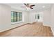 Bright living room featuring wood flooring, a ceiling fan, and large windows with window seats for natural light at 8338 Rittenhouse Cir, Charlotte, NC 28270