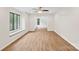 Bright living room featuring wood flooring, a ceiling fan, and large windows with window seats for natural light at 8338 Rittenhouse Cir, Charlotte, NC 28270