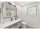 Stylish bathroom with geometric tile, a modern vanity, and a large window for natural light at 9004 Lauriston Pl, Mint Hill, NC 28227