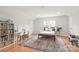Cozy bedroom with hardwood floors, a desk area, and a comfortable bed with a teddy bear at 9004 Lauriston Pl, Mint Hill, NC 28227