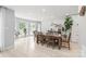 Large dining room with wood flooring, a natural wood table set, and bright natural light at 9004 Lauriston Pl, Mint Hill, NC 28227