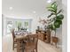 Dining room with wood flooring, a natural wood table set, and bright natural light at 9004 Lauriston Pl, Mint Hill, NC 28227