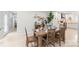 Dining room next to kitchen with table set for four, wood flooring and adjacent kitchen at 9004 Lauriston Pl, Mint Hill, NC 28227