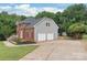 Exterior view of home featuring brick and siding, attached garages, and mature trees at 9004 Lauriston Pl, Mint Hill, NC 28227