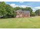 Traditional two-story brick home with a manicured lawn and mature landscaping at 9004 Lauriston Pl, Mint Hill, NC 28227