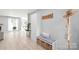 Bright foyer featuring a bench with storage, coat rack, and wood flooring at 9004 Lauriston Pl, Mint Hill, NC 28227