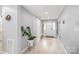 Bright foyer featuring a bench with storage, coat rack, and wood flooring at 9004 Lauriston Pl, Mint Hill, NC 28227