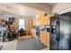 Spacious garage area with kitchen area, cabinets, and a full sized refrigerator at 9004 Lauriston Pl, Mint Hill, NC 28227