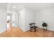 Bright hallway with hardwood floors, white walls, and recessed lighting, creating a clean aesthetic at 9004 Lauriston Pl, Mint Hill, NC 28227