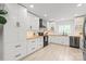 Modern kitchen with stainless steel appliances, light wood counters and white cabinetry at 9004 Lauriston Pl, Mint Hill, NC 28227