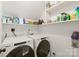 Functional laundry room with a Whirlpool washer and dryer and shelving for storage at 9004 Lauriston Pl, Mint Hill, NC 28227