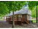 Backyard view featuring a wooden deck, staircase, and privacy fence at 901 Brighton Dr, Kannapolis, NC 28081