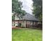Well-maintained backyard with a lush lawn, privacy fence, and a view of the home's exterior at 901 Brighton Dr, Kannapolis, NC 28081