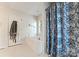 Bright white bathroom with soaking tub and shower behind a floral curtain at 901 Brighton Dr, Kannapolis, NC 28081