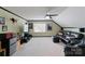 Spacious bonus room with TV, mini-fridge, and ceiling fan at 901 Brighton Dr, Kannapolis, NC 28081