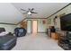 Spacious bonus room features a ceiling fan, TV, and comfortable leather seating at 901 Brighton Dr, Kannapolis, NC 28081