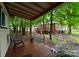 Relaxing covered deck with a chair that leads to the backyard and large deck at 901 Brighton Dr, Kannapolis, NC 28081