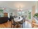 Dining room with hardwood floors and chandelier lighting with natural light shining through the bay windows at 901 Brighton Dr, Kannapolis, NC 28081