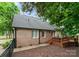 Exterior view of brick house with fenced in yard, and access to the back deck at 901 Brighton Dr, Kannapolis, NC 28081