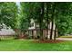 A beautiful view of the property showcasing a well-manicured lawn and mature trees at 901 Brighton Dr, Kannapolis, NC 28081