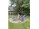 Outdoor fire pit with stone surround and chairs, perfect for relaxing and entertaining in the backyard at 901 Brighton Dr, Kannapolis, NC 28081