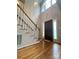 Inviting foyer with hardwood floors, a staircase with white railings, and a contemporary light fixture at 901 Brighton Dr, Kannapolis, NC 28081