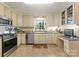 Well-lit kitchen with stainless steel appliances, ample cabinet space and a view of the outdoors at 901 Brighton Dr, Kannapolis, NC 28081