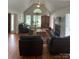 Cozy living room with hardwood floors, a fireplace, and large windows offering plenty of natural light at 901 Brighton Dr, Kannapolis, NC 28081