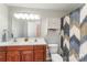 Well-lit bathroom featuring a double sink vanity, modern fixtures, and a stylish shower curtain at 910 W A St, Kannapolis, NC 28081