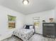 This charming bedroom features neutral paint, plenty of natural light, and minimalist decor at 910 W A St, Kannapolis, NC 28081
