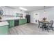 Functional eat-in kitchen with green and white cabinetry, modern appliances, and sleek, stylish flooring at 910 W A St, Kannapolis, NC 28081