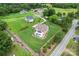 Aerial view of a stunning property with a pool, lush landscaping, and a well-maintained lawn at 9125 Dylan Ridge Ct, Concord, NC 28027
