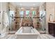Gorgeous bathroom featuring a soaking tub, stone tile, and glass enclosed shower at 9125 Dylan Ridge Ct, Concord, NC 28027