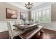 Dining area featuring a rustic wooden table, elegant seating, and abundant natural light at 9125 Dylan Ridge Ct, Concord, NC 28027