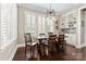 Elegant dining room featuring a large window, built-in shelving and a modern chandelier at 9125 Dylan Ridge Ct, Concord, NC 28027