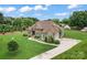 Beautiful exterior elevation of a two-story home showcasing stone accents, manicured lawn, and a paved driveway at 9125 Dylan Ridge Ct, Concord, NC 28027