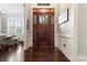 Welcoming foyer featuring a dark hardwood floor, decorative front door, and views into other living spaces at 9125 Dylan Ridge Ct, Concord, NC 28027