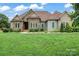 Charming home displaying a well-manicured lawn, complemented by stone and siding exterior finishes at 9125 Dylan Ridge Ct, Concord, NC 28027