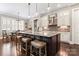 Large kitchen island with granite countertops and pendant lighting at 9125 Dylan Ridge Ct, Concord, NC 28027