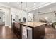 Kitchen island with granite countertop and stainless steel appliances at 9125 Dylan Ridge Ct, Concord, NC 28027