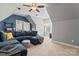 Living room with comfortable seating, a ceiling fan, and plenty of light from the windows at 9125 Dylan Ridge Ct, Concord, NC 28027