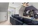 Living room with an accent wall, shelving, large television, and comfy seating at 9125 Dylan Ridge Ct, Concord, NC 28027