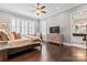 Serene main bedroom with natural light, neutral tones, wood floors, and ensuite bathroom access at 9125 Dylan Ridge Ct, Concord, NC 28027