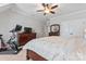 Spacious main bedroom with a large bed, ceiling fan, dresser and storage, plus exercise equipment at 9125 Dylan Ridge Ct, Concord, NC 28027