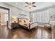 Serene main bedroom with natural light, neutral tones, wood floors, and stylish furnishings at 9125 Dylan Ridge Ct, Concord, NC 28027
