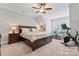Spacious main bedroom with a comfortable seating area, king bed, and access to exercise equipment at 9125 Dylan Ridge Ct, Concord, NC 28027